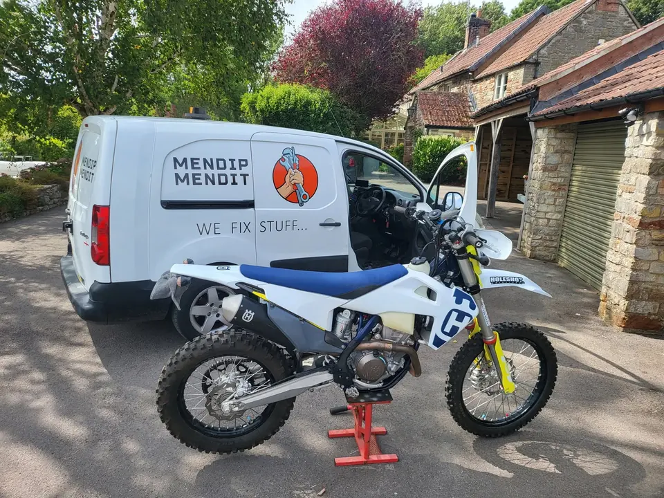 Work on a Husqvarna FE350 at a customer’s home, with the Mendip Mendit van alongside.