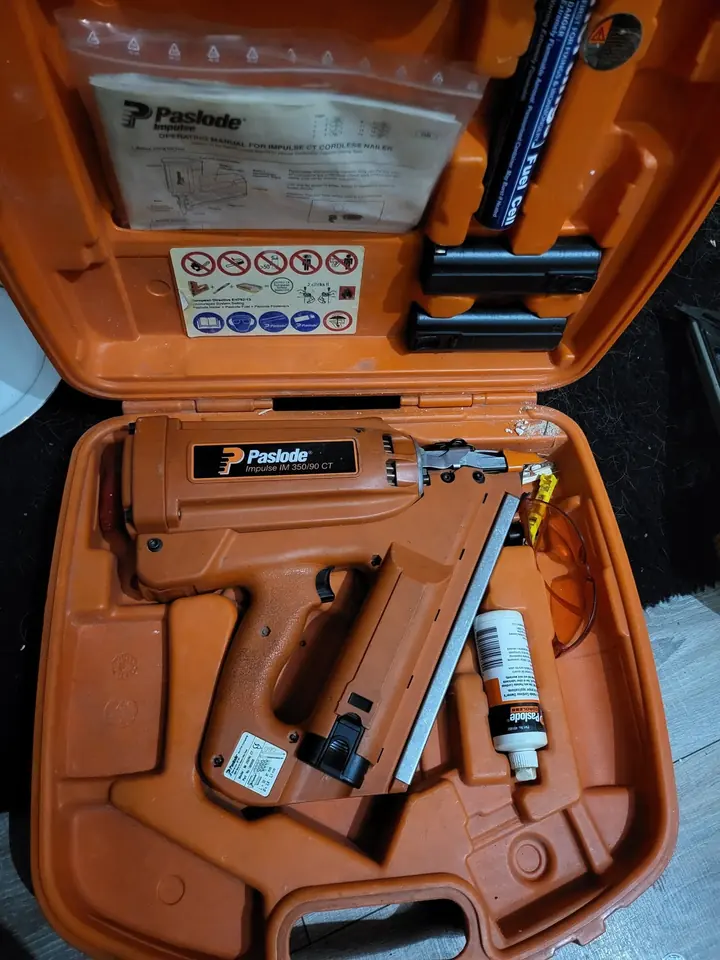 A Paslode nail gun in its case after repair and servicing.